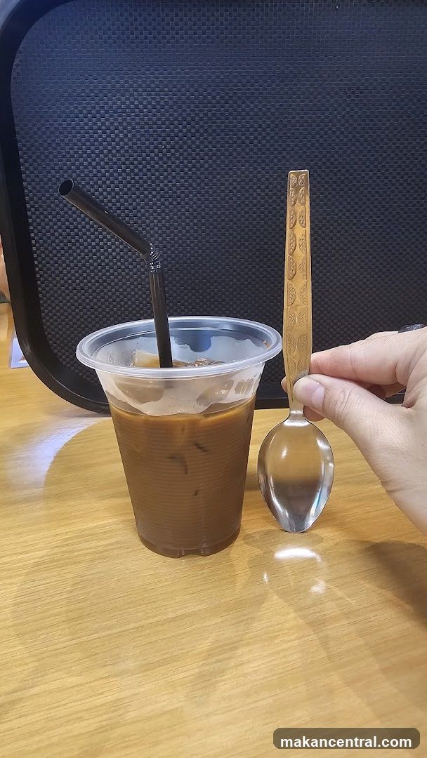 Iced coffee with spoon and straw