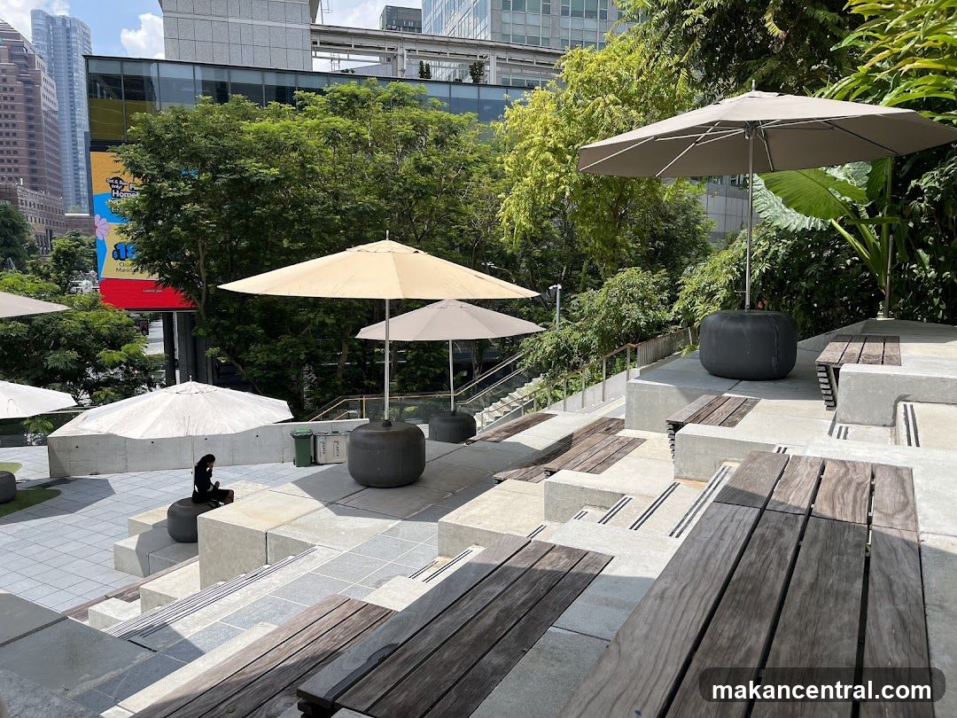 Outdoor seating area with umbrellas and greenery