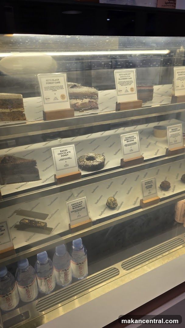 Display Case with Desserts and Water Bottles