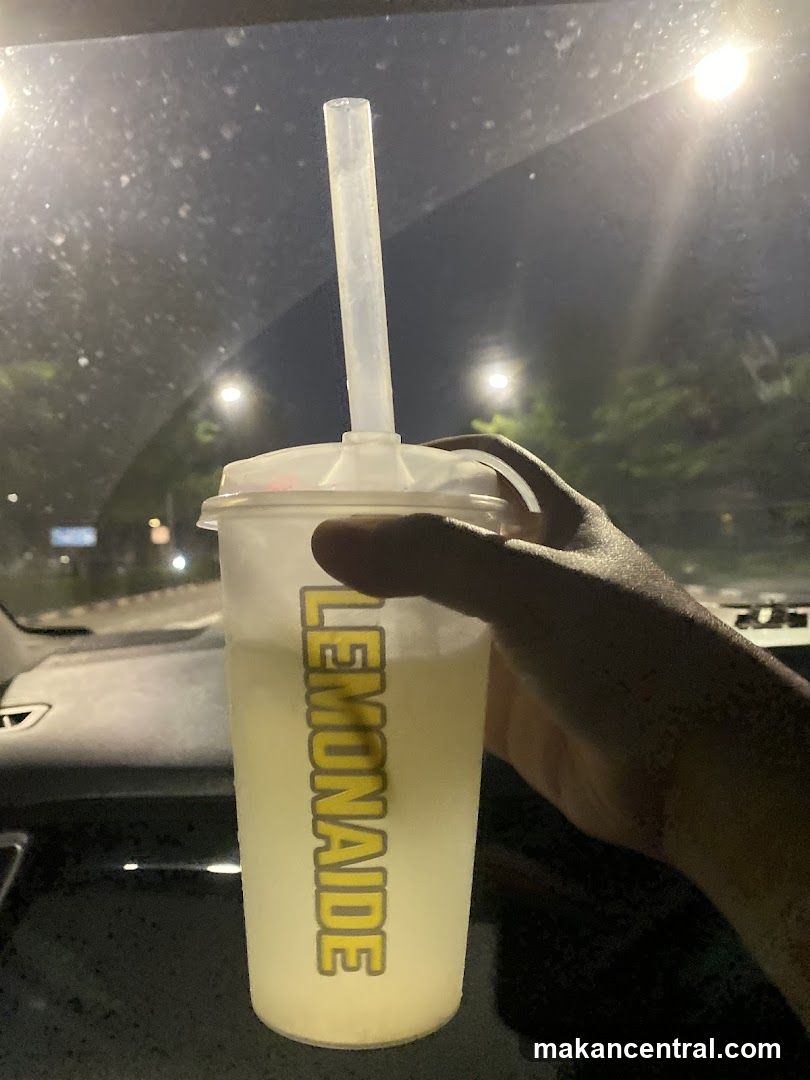 Lemonaide drink held in car at night