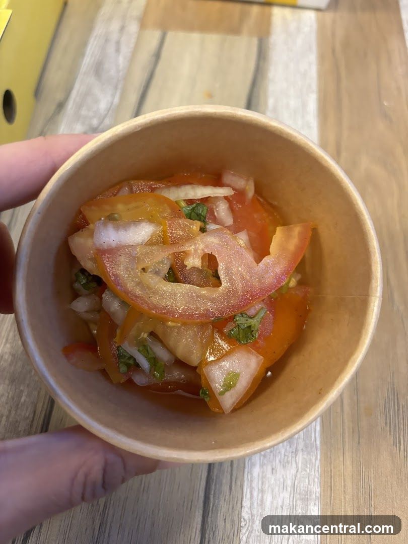Hand holding a bowl of salad