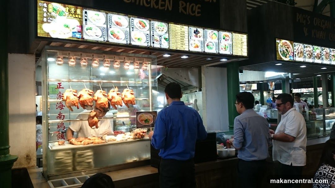 Food stall interior with customers and roasted chickens