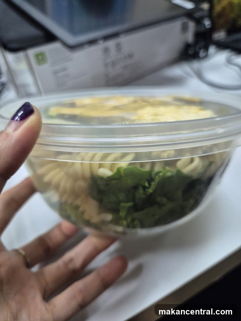 Hand holding a meal container