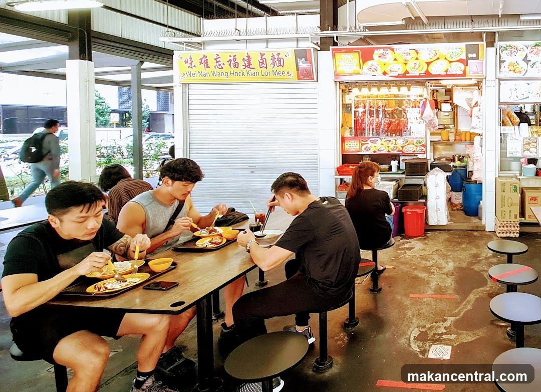 People dining at a hawker center stall