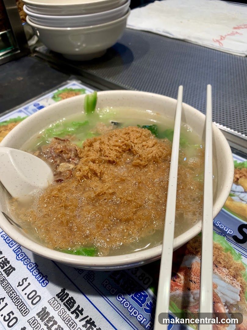 Bowl of soup with chopsticks and spoon