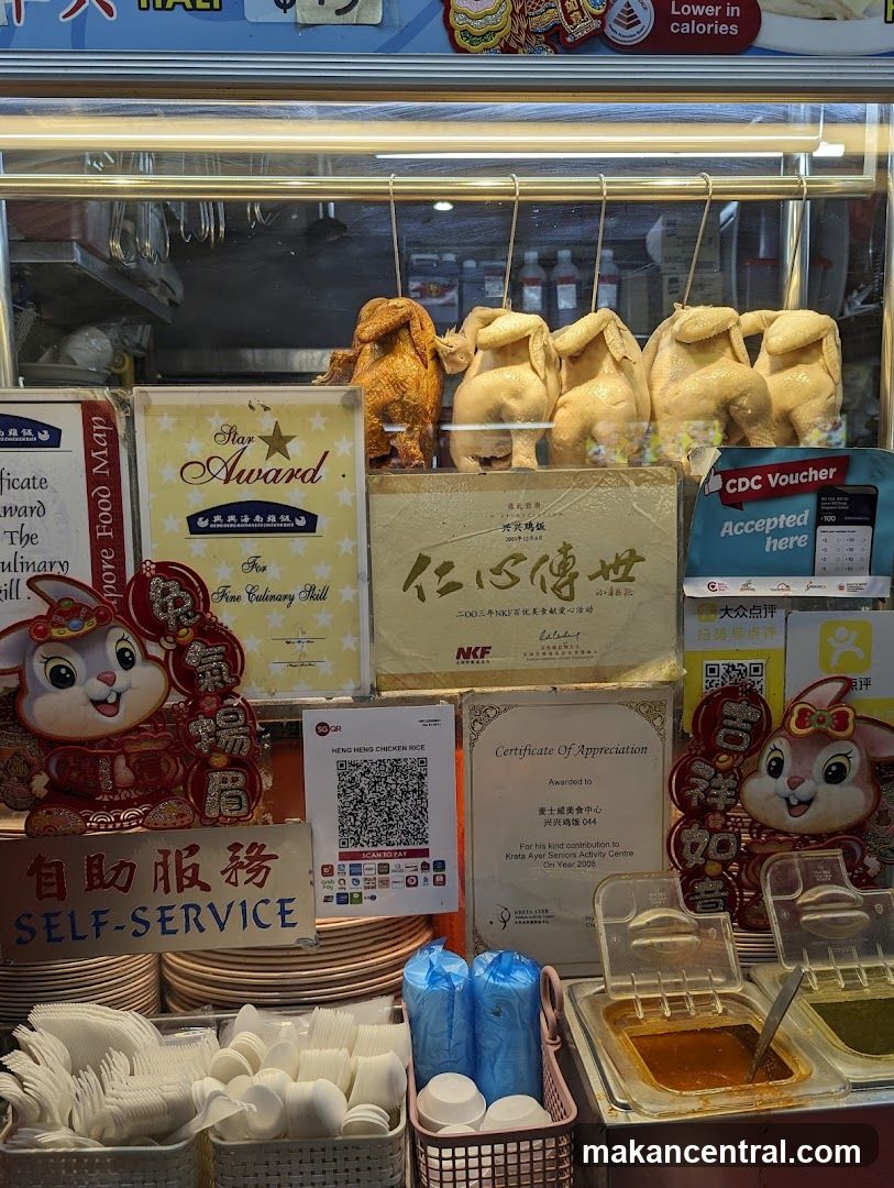 Food stall display with roasted chickens and certificates