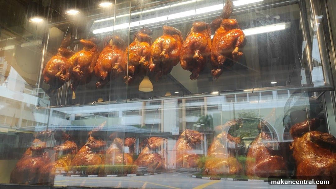 Roasted chickens displayed in glass case