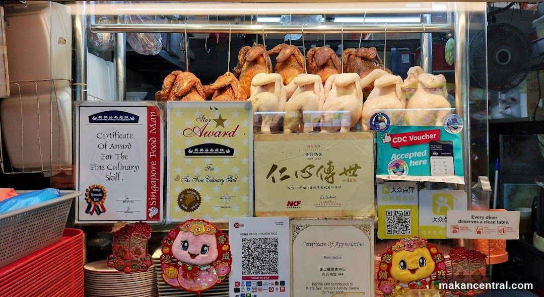 Food stall display with roasted chickens and awards