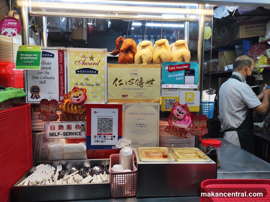 Food stall interior with promotional materials and cooking display