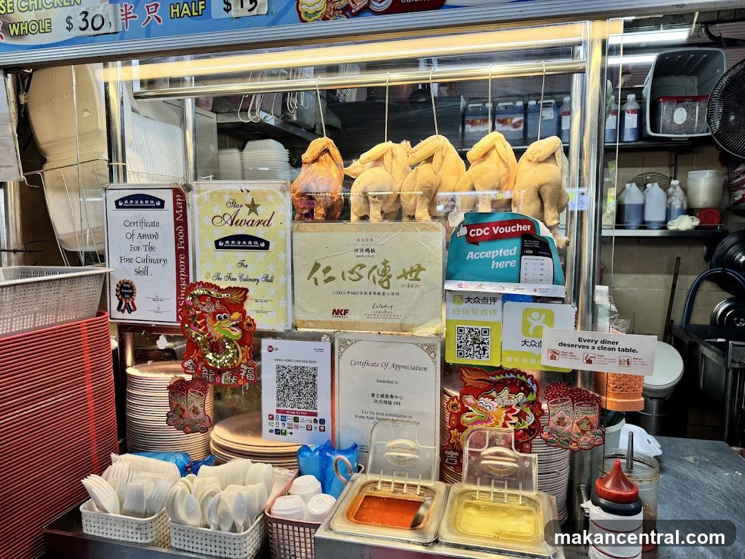 Food stall interior with chicken display and awards