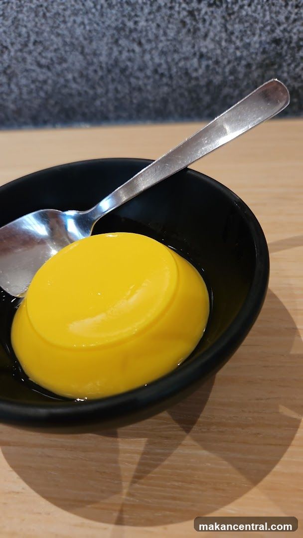 Yellow Dessert in Black Bowl