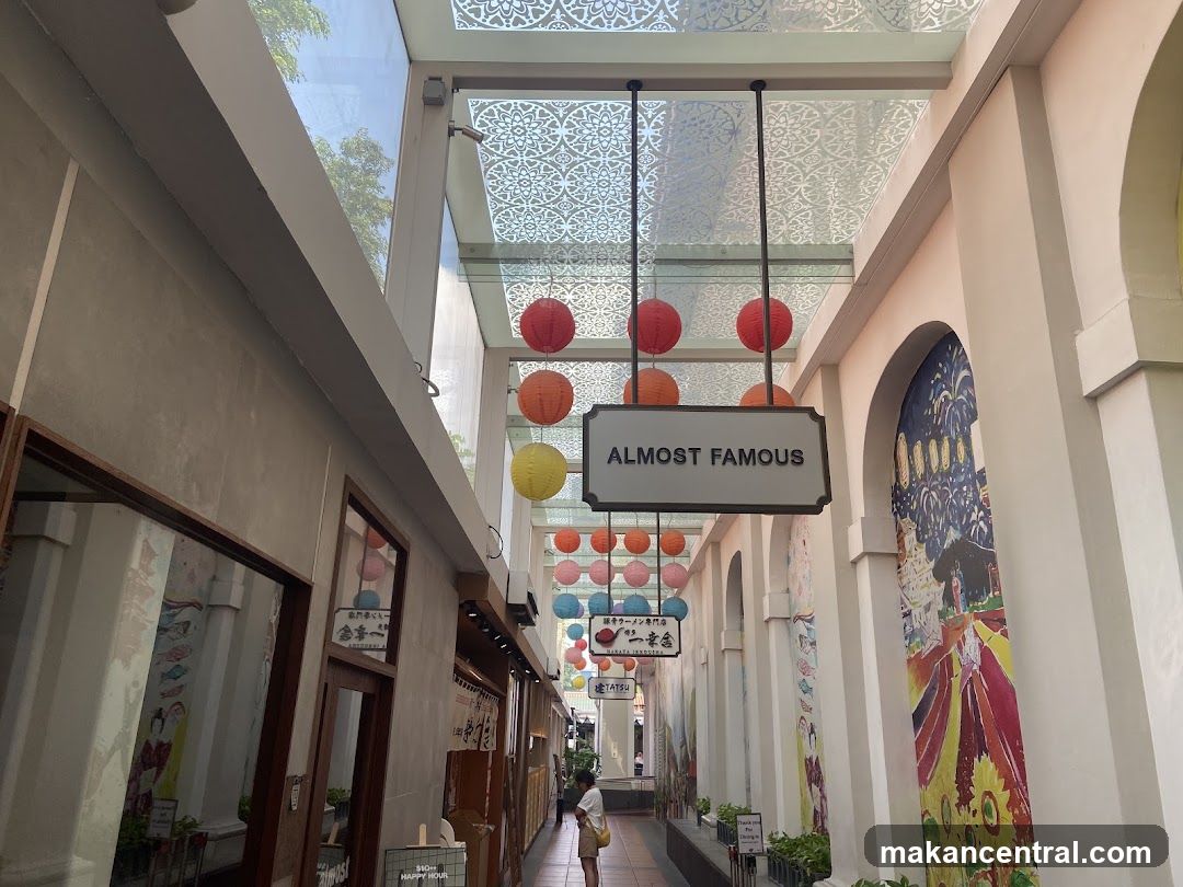 Interior walkway with hanging lanterns and signage