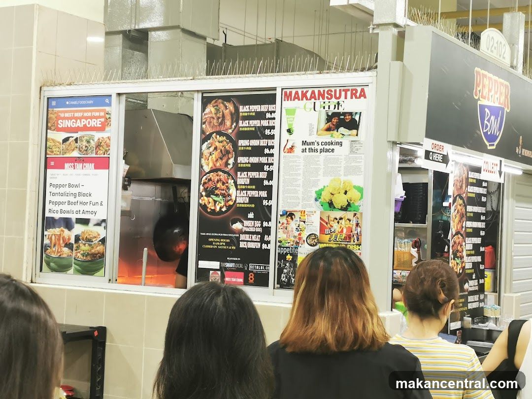 Food stall interior with customers waiting