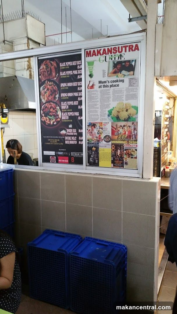 Food stall interior with menu board and promotional posters