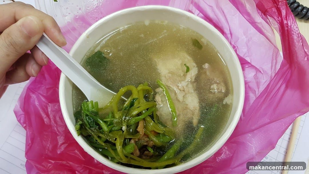 Bowl of soup with greens and meat