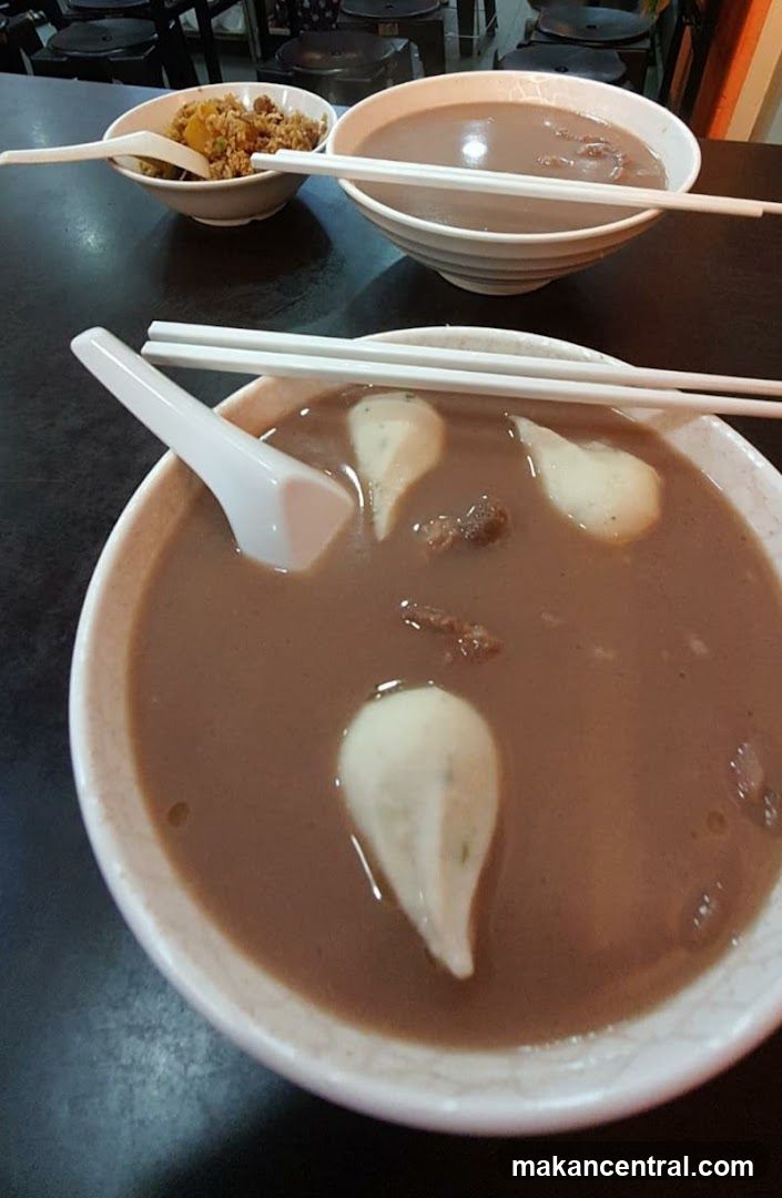 Table with bowls of soup and side dish