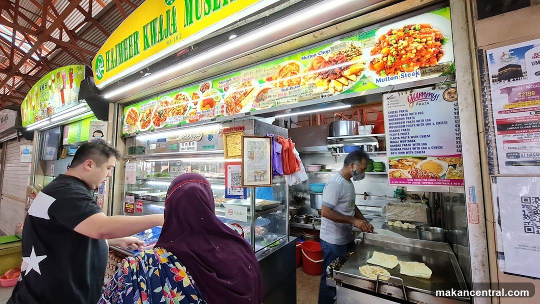 Food stall interior with customers and staff