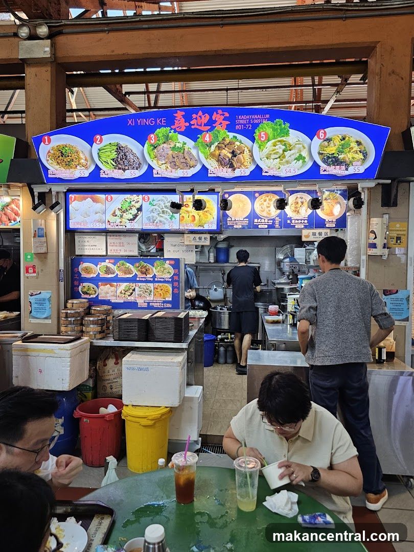 Food stall interior with customers and staff