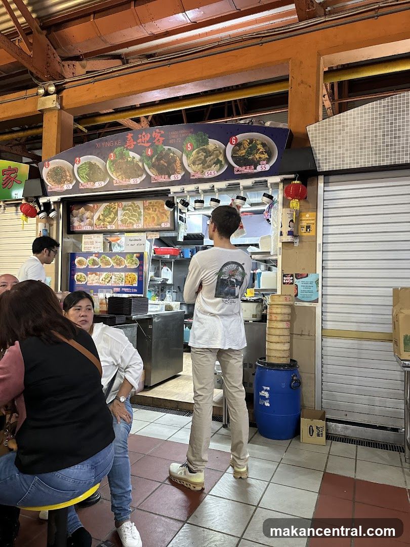 Food stall interior with customers and staff