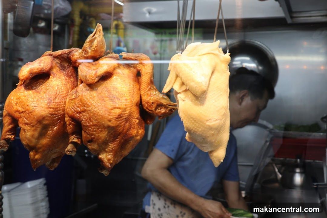 Roasted chickens displayed in a food stall