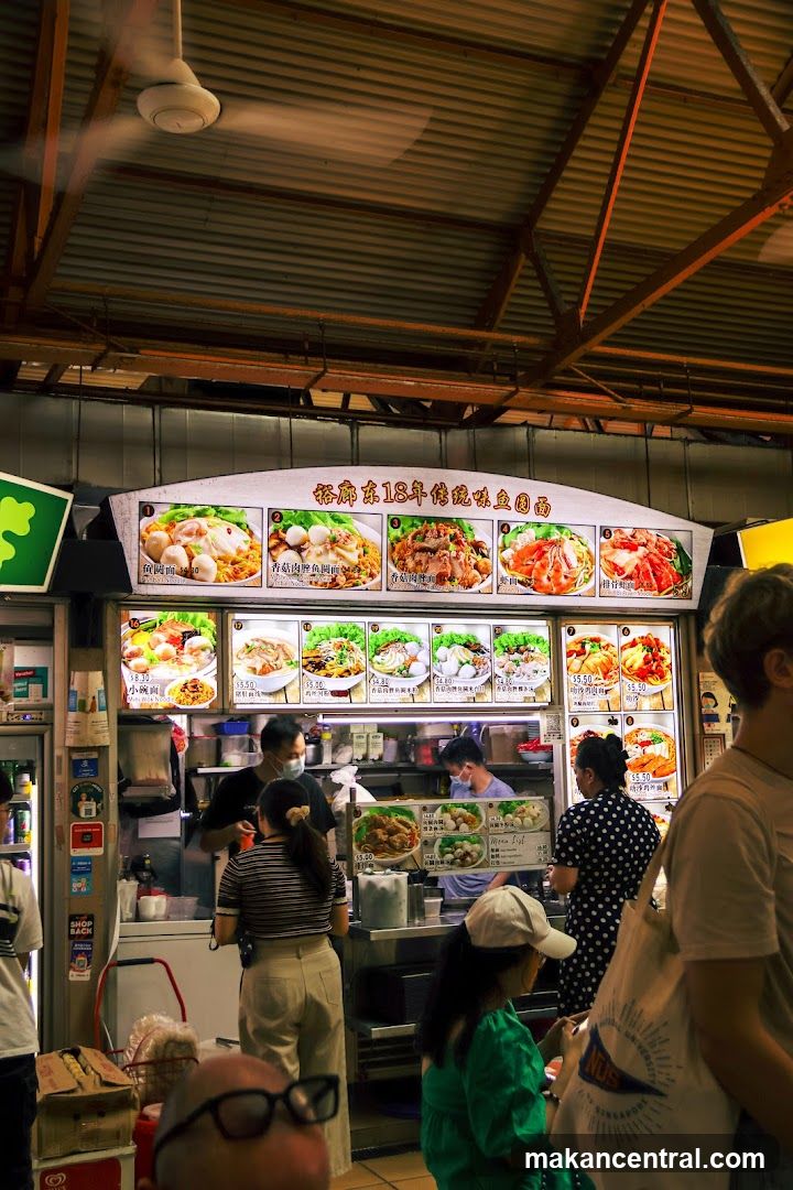 Food stall interior with customers and staff