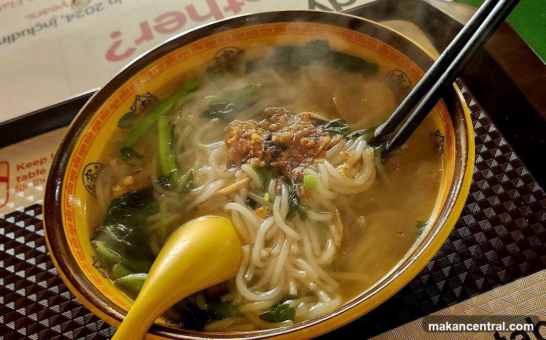 Hot noodle soup with chopsticks and spoon