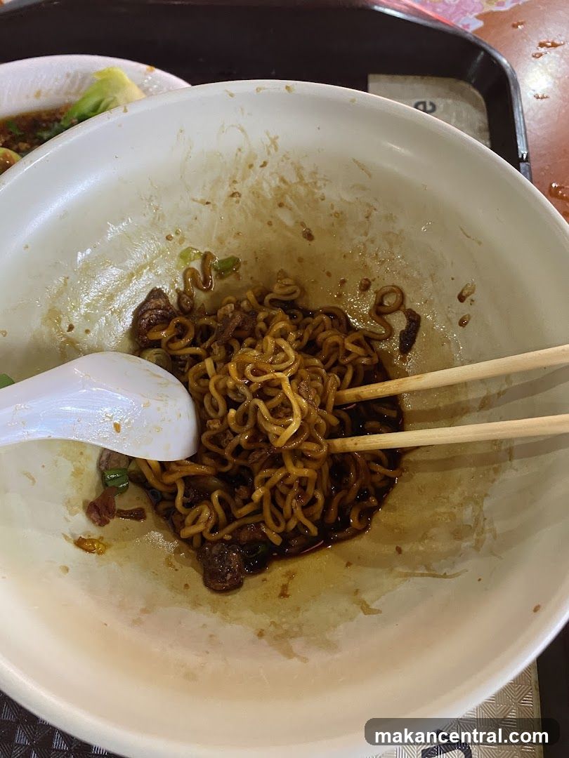 Noodles in bowl with chopsticks and spoon