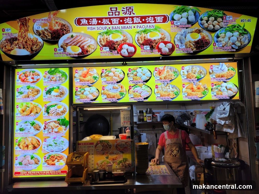 Food stall with bright yellow signage