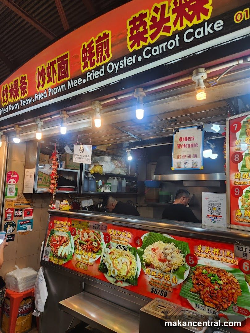 Food stall interior with signage and staff