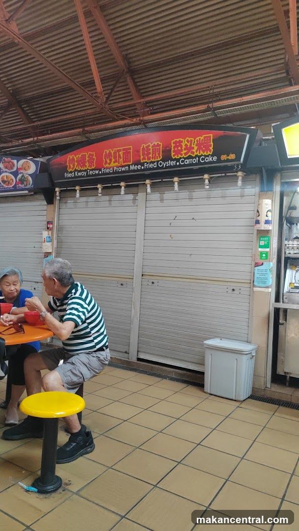 Two elderly patrons dining at an outdoor food stall