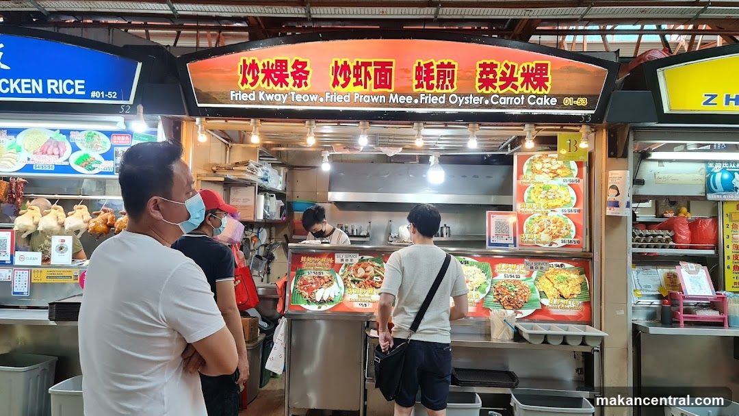 Food stall interior with customers and staff