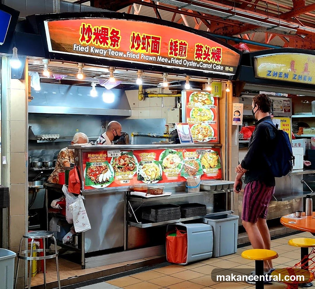 Food stall interior with customers and staff