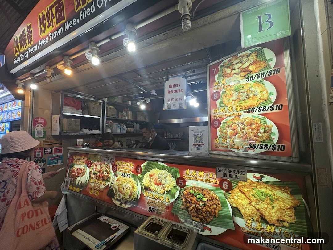 Food stall interior with customers and staff