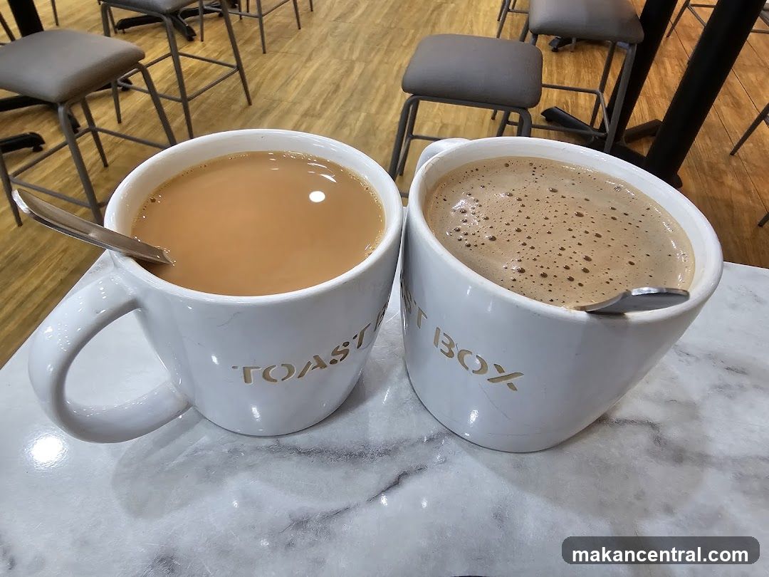 Two mugs of beverages at Toast Box