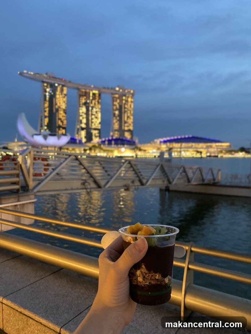 Hand holding dessert with Marina Bay Sands in background