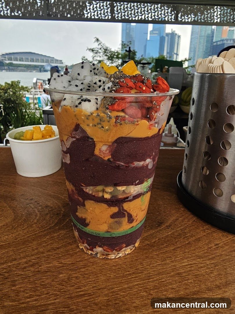 A layered smoothie bowl with cityscape background