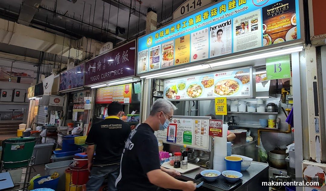 Food stall interior with staff and signage