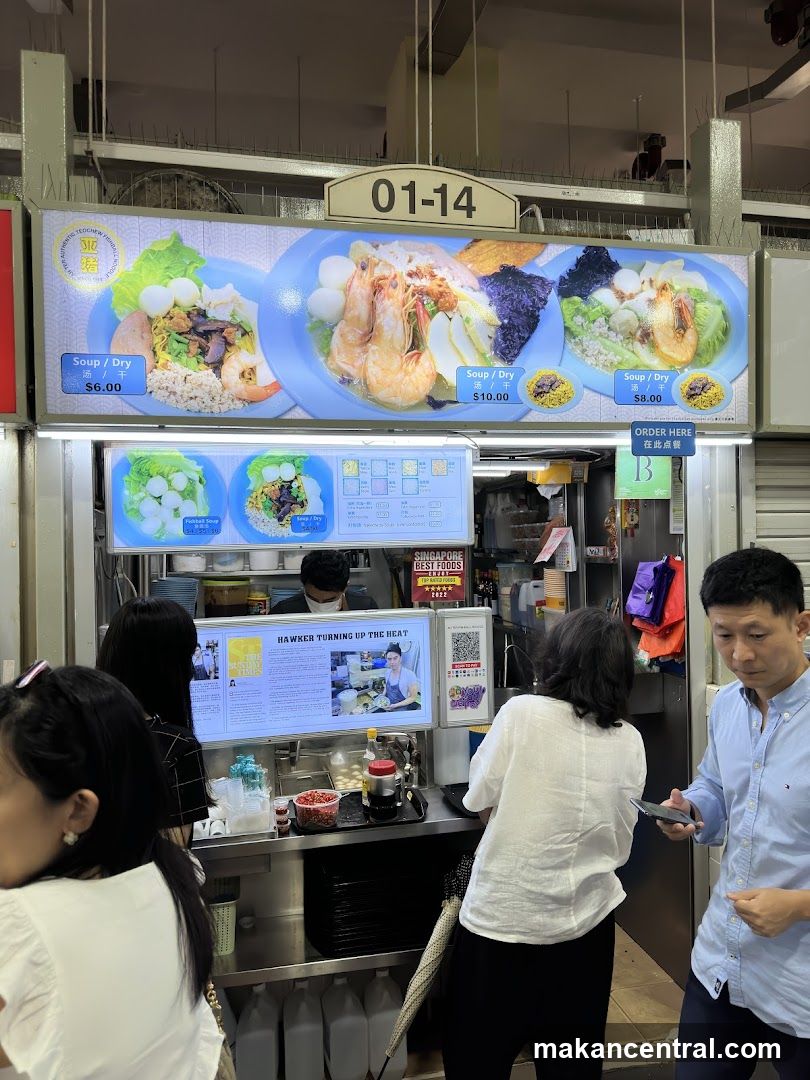 Food stall interior with customers and digital display