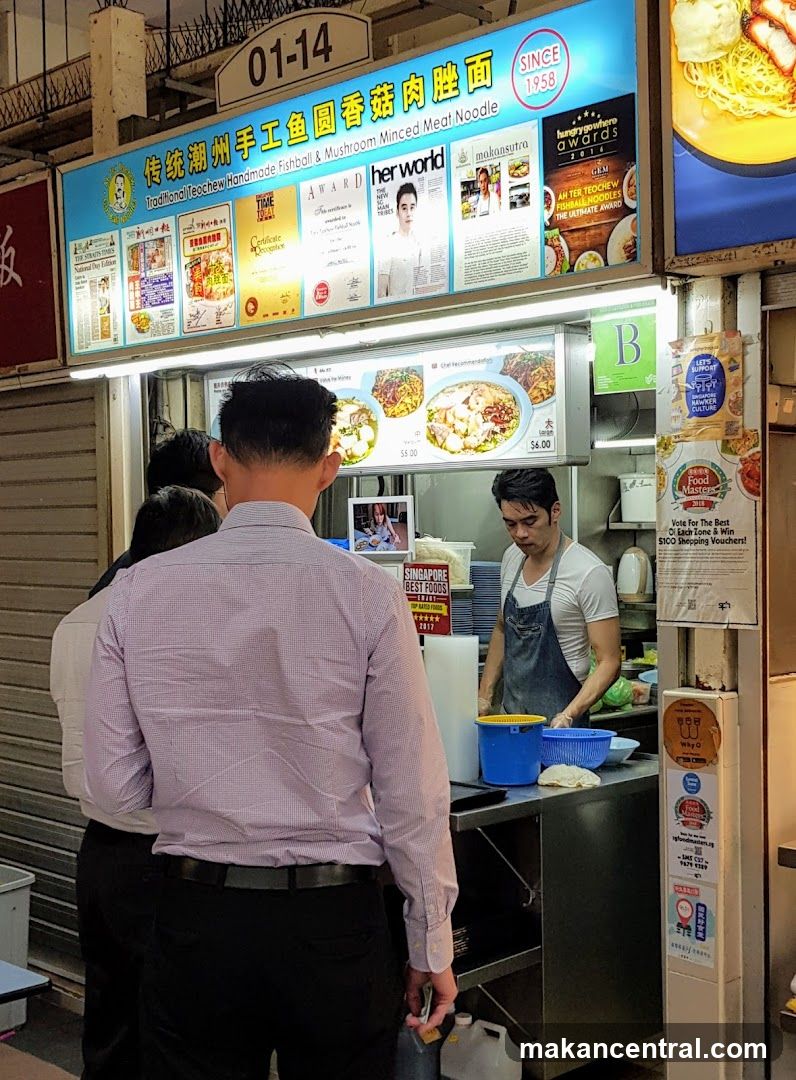Food stall interior with customers and staff