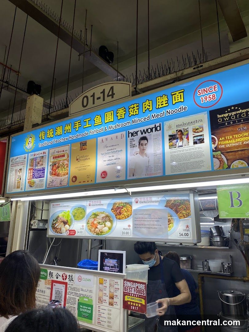 Food stall interior with signage and staff