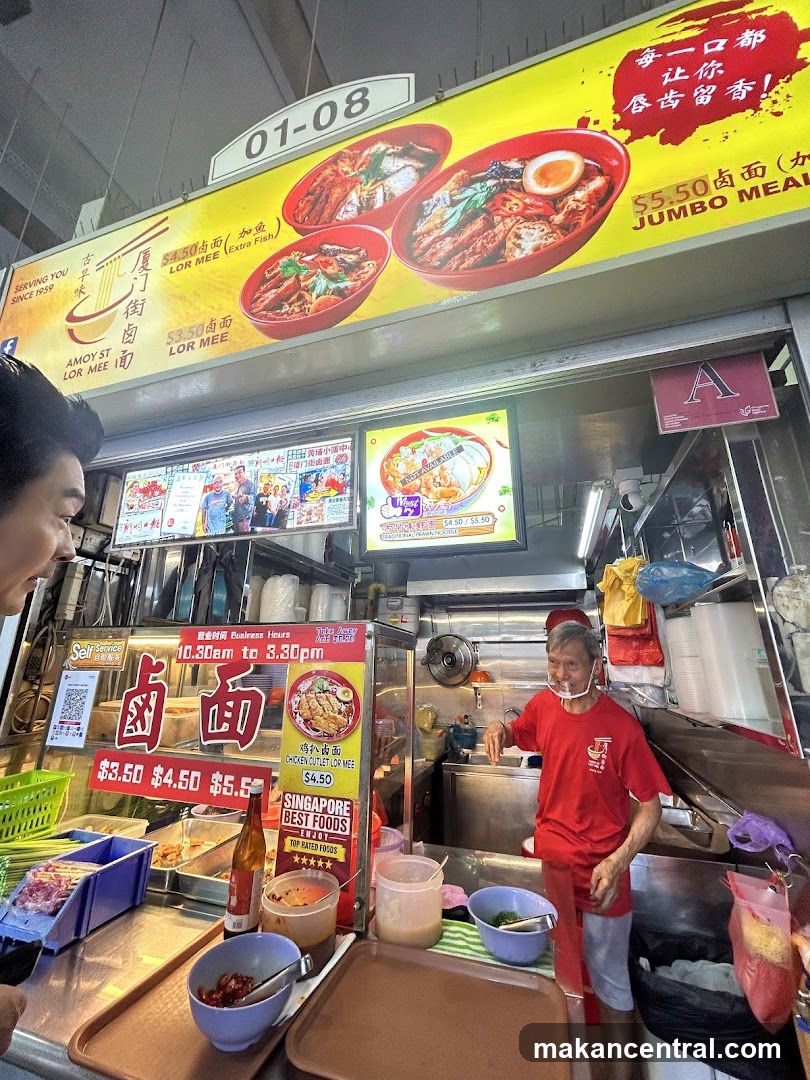 Food stall interior with staff and signage