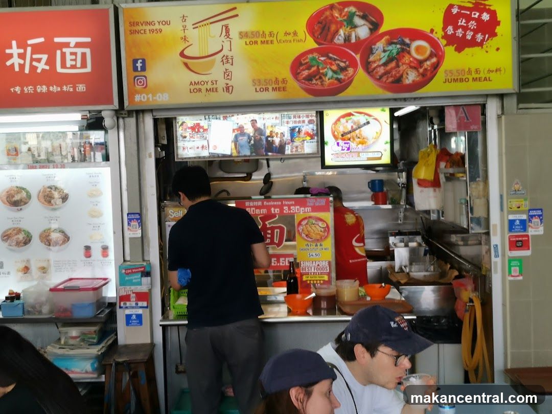 Food stall interior with customers and staff