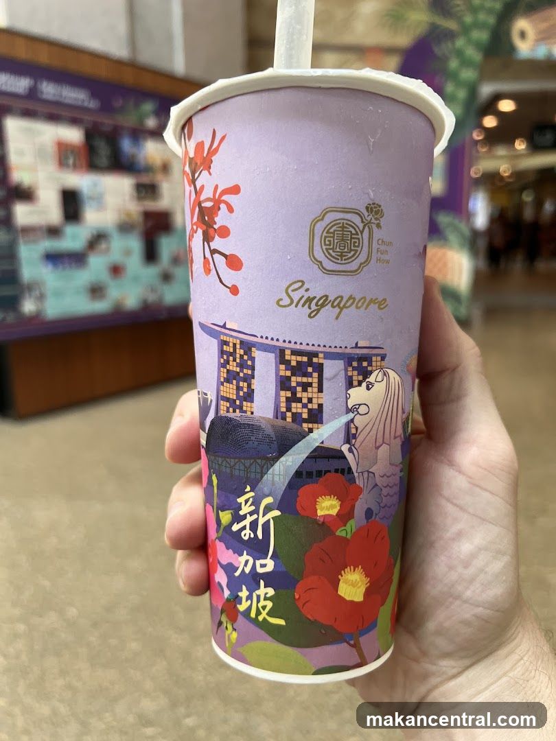 Hand holding Singapore-themed drink cup