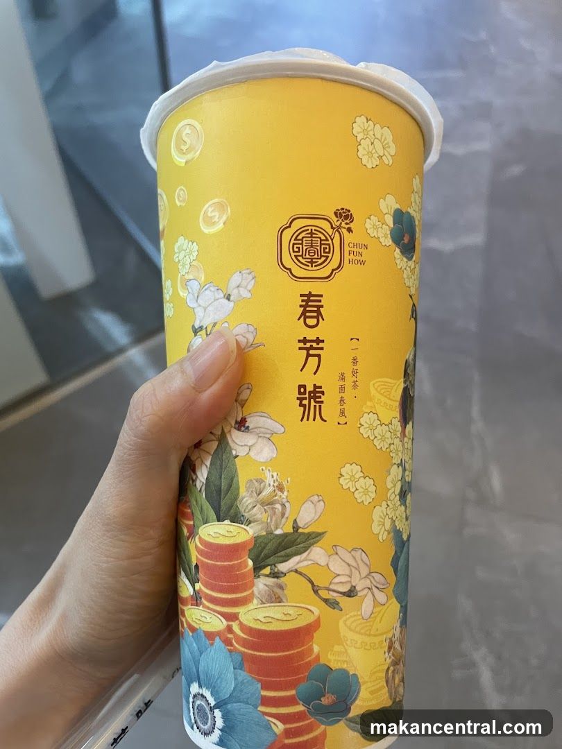Hand holding branded beverage cup