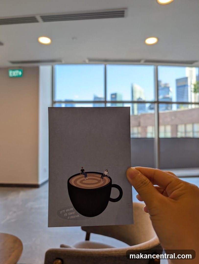 Hand holding printed card in café interior