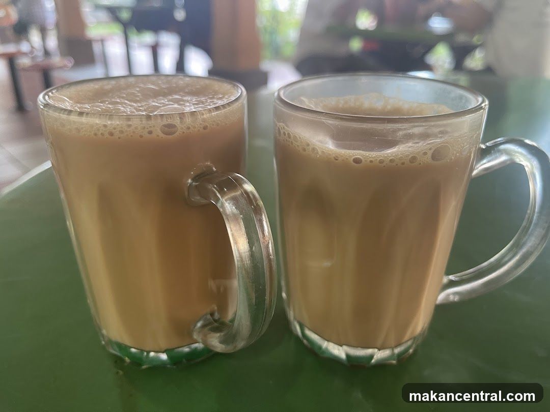 Two mugs of tea on a green table