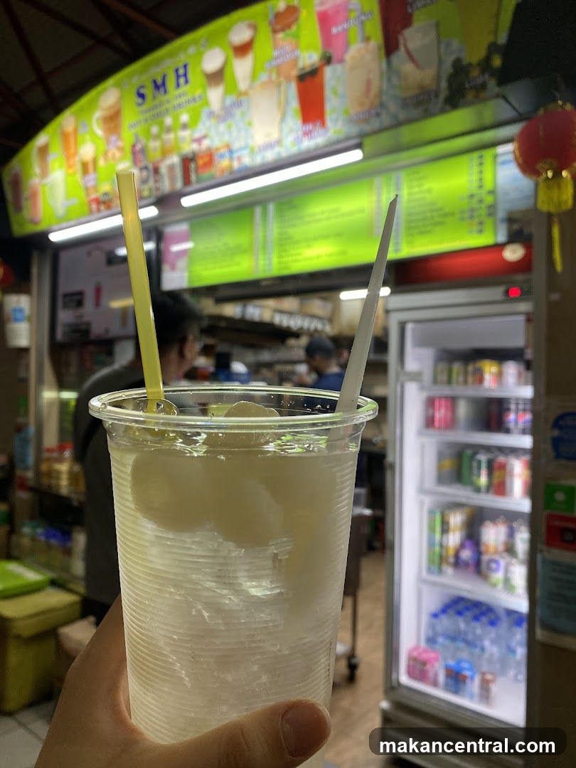 Hand holding drink in food stall