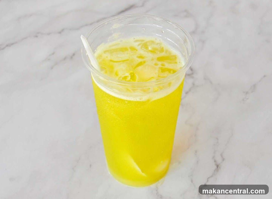 Yellow beverage in plastic cup