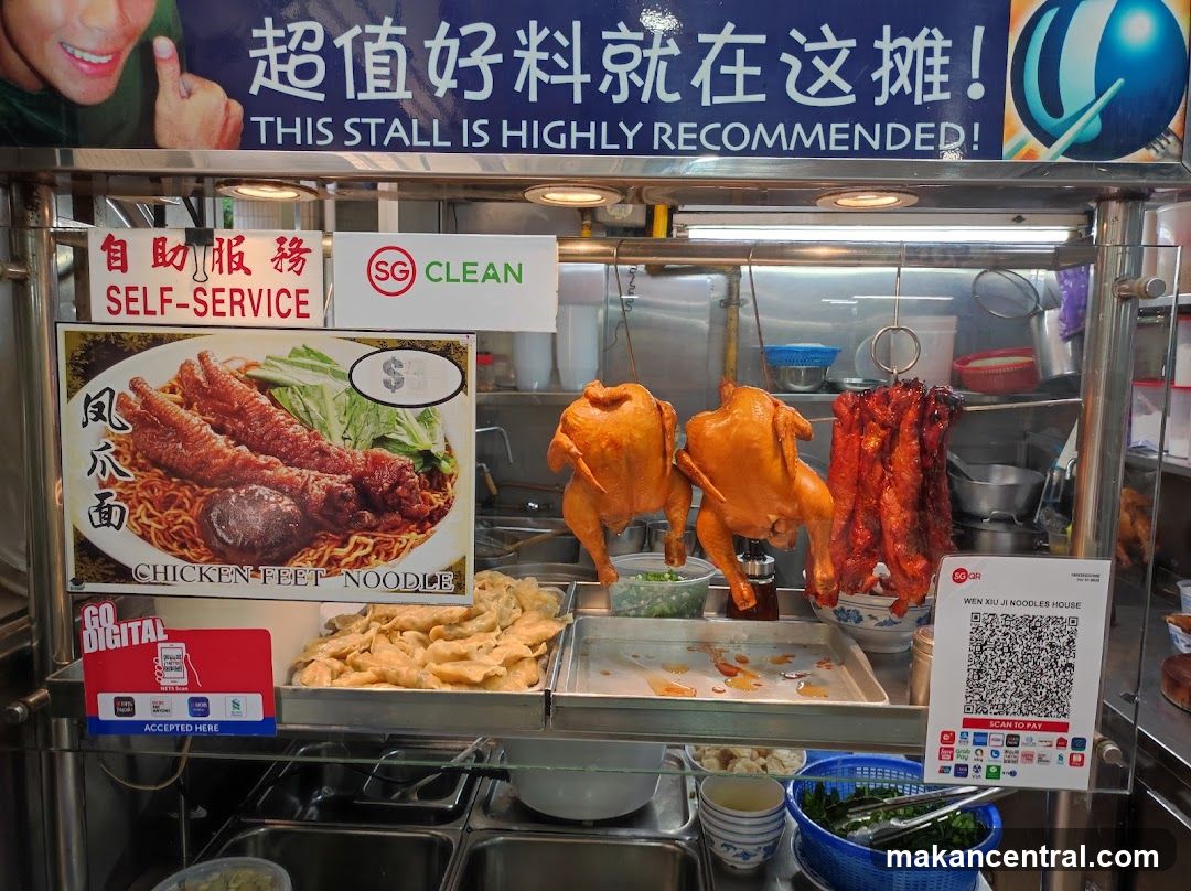 Food stall interior with roasted meats and self-service signage