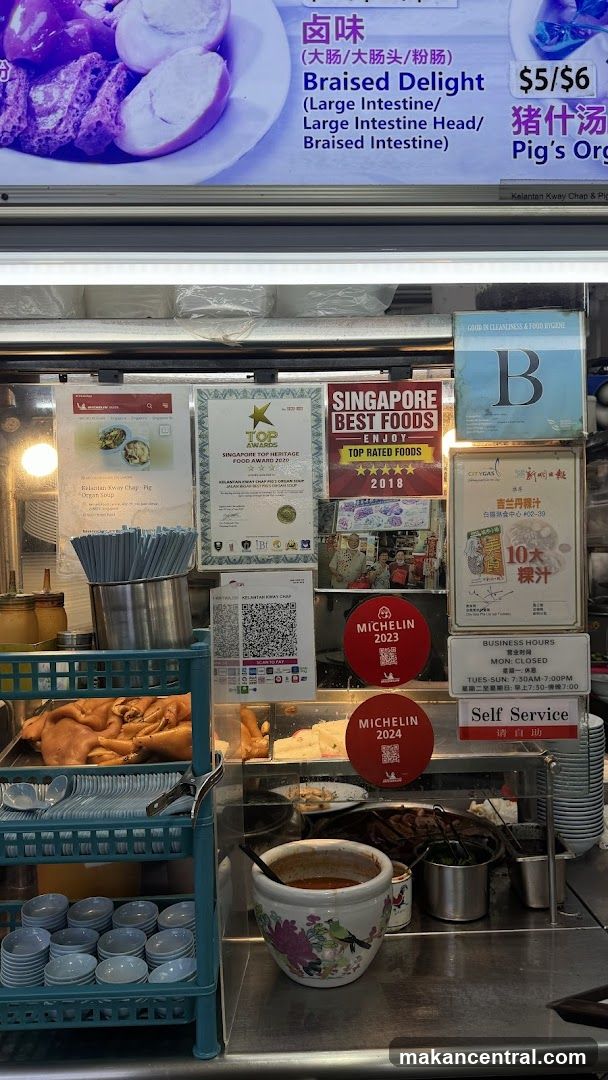 Food stall interior with awards and signage
